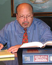 Photo of Peter J. Pietrandrea II reading legal references