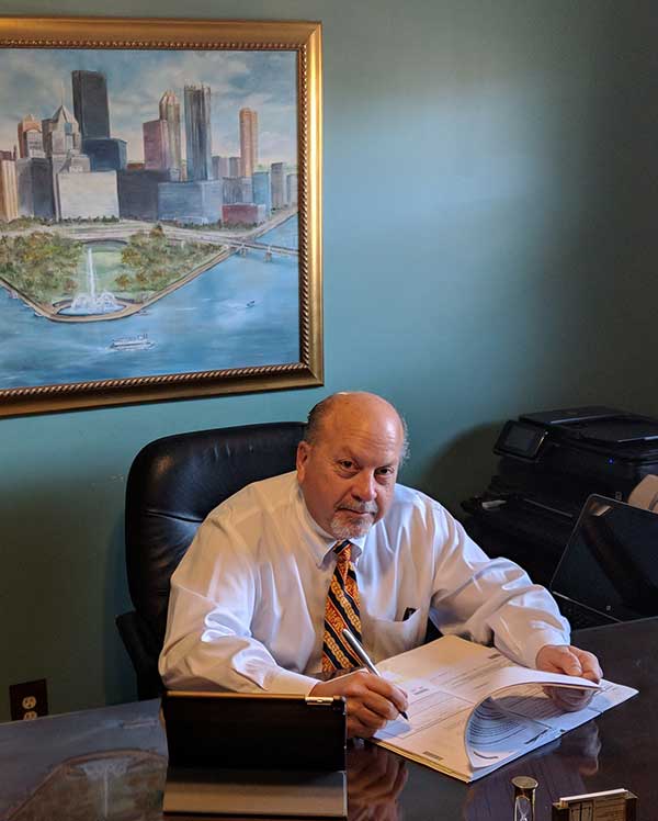 Photo of Peter J. Pietrandrea II sitting at his desk